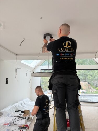 Electricians fixing lights in Wimbledon